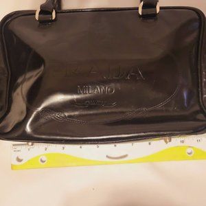 Prada black shinny satchel with feet on the bottom